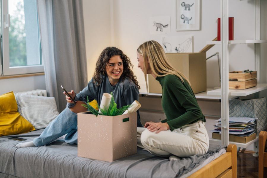 Deux étudiantes dans une chambre à Paris préparant leurs cartons pour le stockage